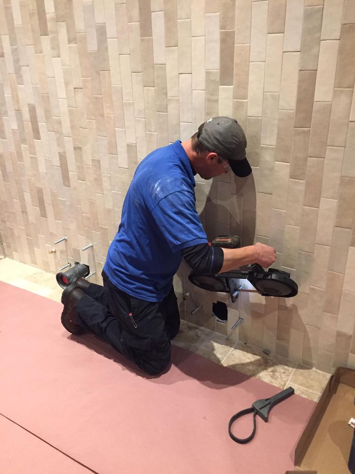  Technician installing toilet mount at the Gloria Theater in Urbana.